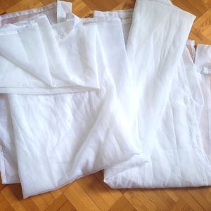 Two white and transparent curtains .